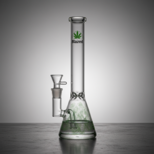 Een helder glazen waterpijp met een bekerbasis, gelabeld Blazed en voorzien van een groen cannabisbladlogo, ligt op een glad oppervlak tegen een neutrale grijze achtergrond - perfect voor je DailyBlaze-ritueel. - DailyBlaze